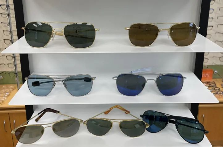 Optician fitting prescription sunglasses with H2O Blue lens technology in Newtonville