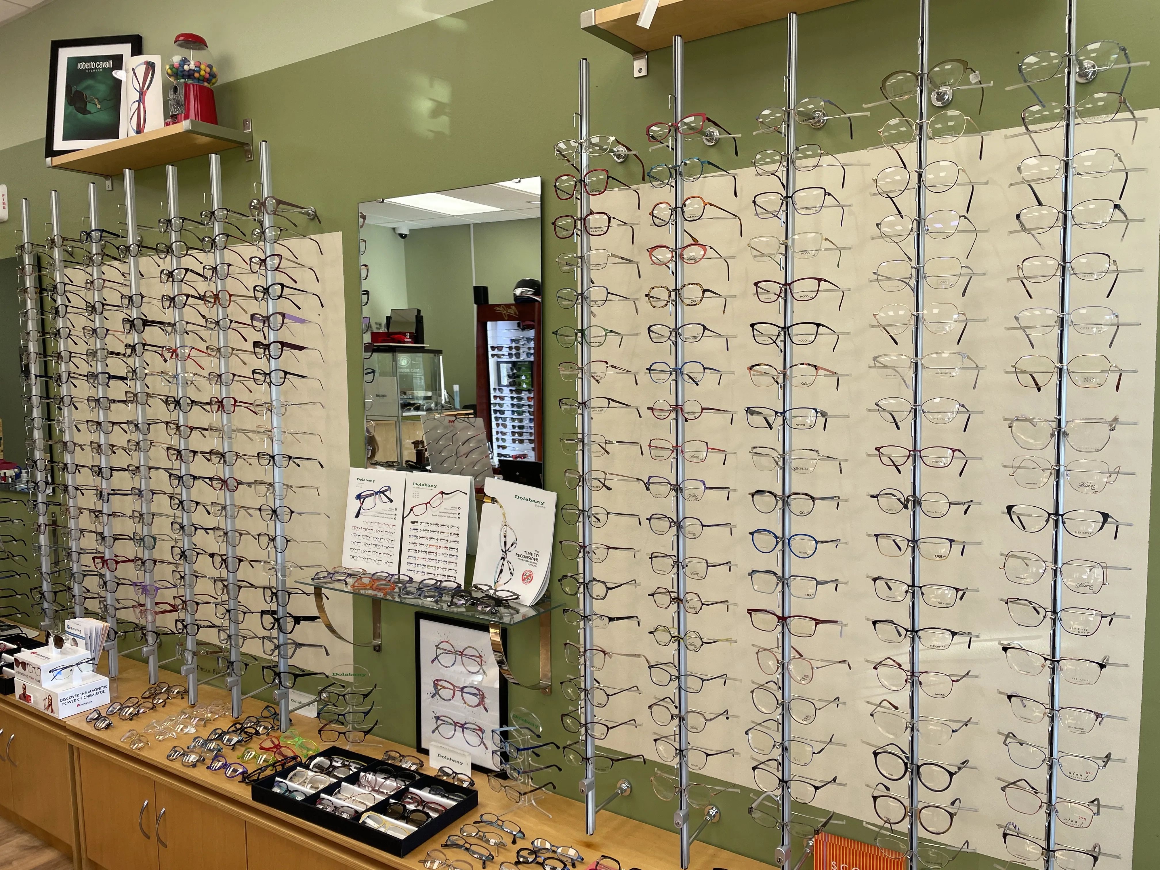 Optician guiding client through frame selection based on face shape in Newtonville